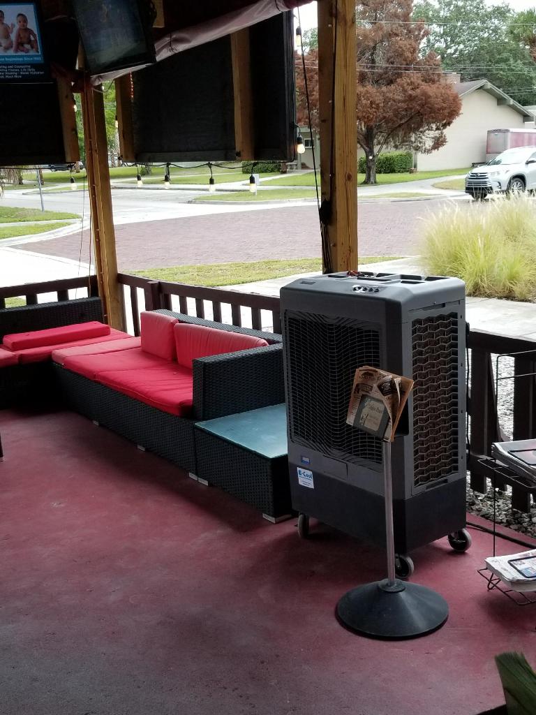 Outdoor patio with seating and an air cooler.