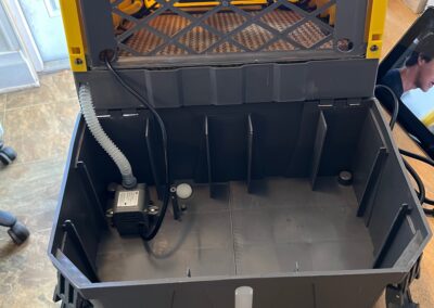 Open yellow toolbox with compartments and cables inside.