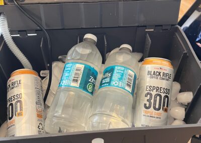 Cooler with bottles and cans on ice