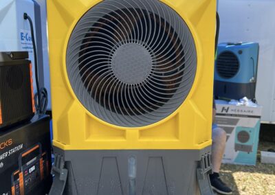 Portable yellow fan on display table.