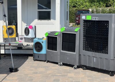 Various evaporative coolers displayed outside for sale.