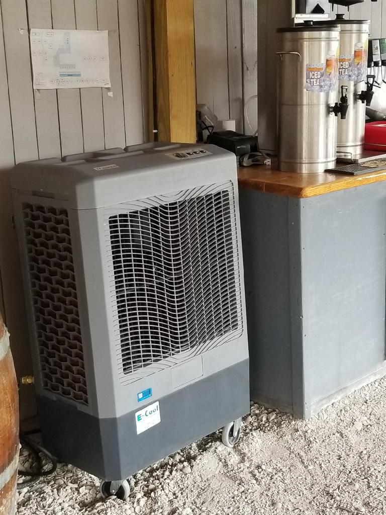 Portable air cooler next to tea dispensers