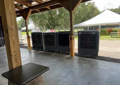 Outdoor event space with cooling units and tents.