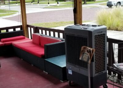 Outdoor patio with seating and portable air cooler.