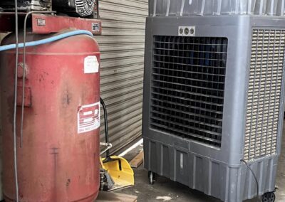 Industrial air compressor and evaporative cooler in warehouse