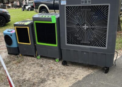 Outdoor portable air coolers lined up on pavement.