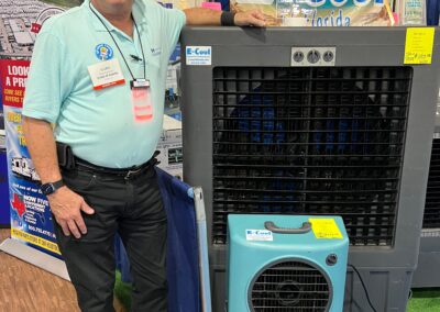 Man showcasing E-Cool cooling systems at trade show.
