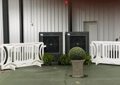 Indoor fans with white barriers and potted plants