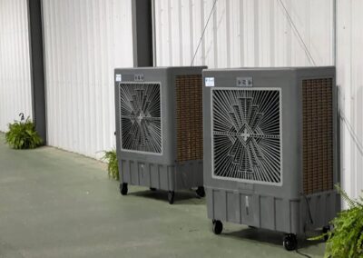 Two large portable coolers by warehouse wall