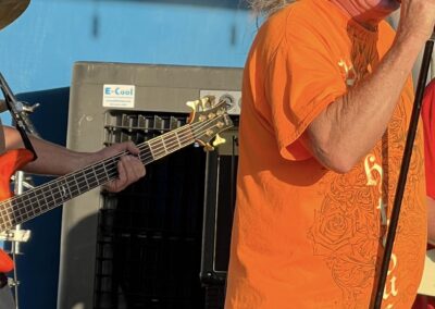 Singer performing on stage with guitarist.