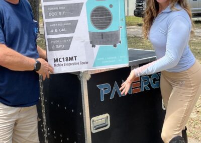 Two people presenting Hessaire cooler box outdoors.