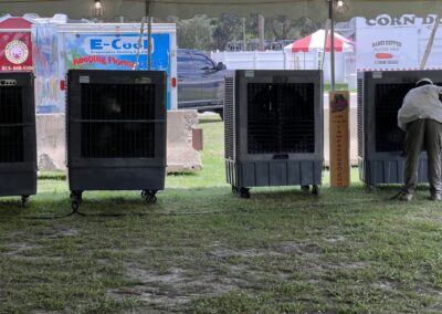 Cooling systems under event tent with grass.