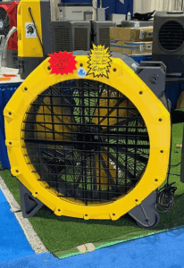 Large yellow industrial fan at exhibition display.