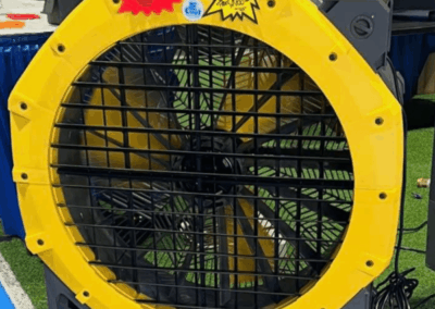 Large yellow industrial fan at exhibition display.
